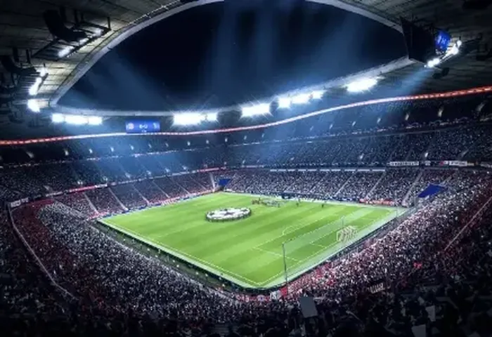 Packed, brightly lit football stadium at night, representing live sports coverage
